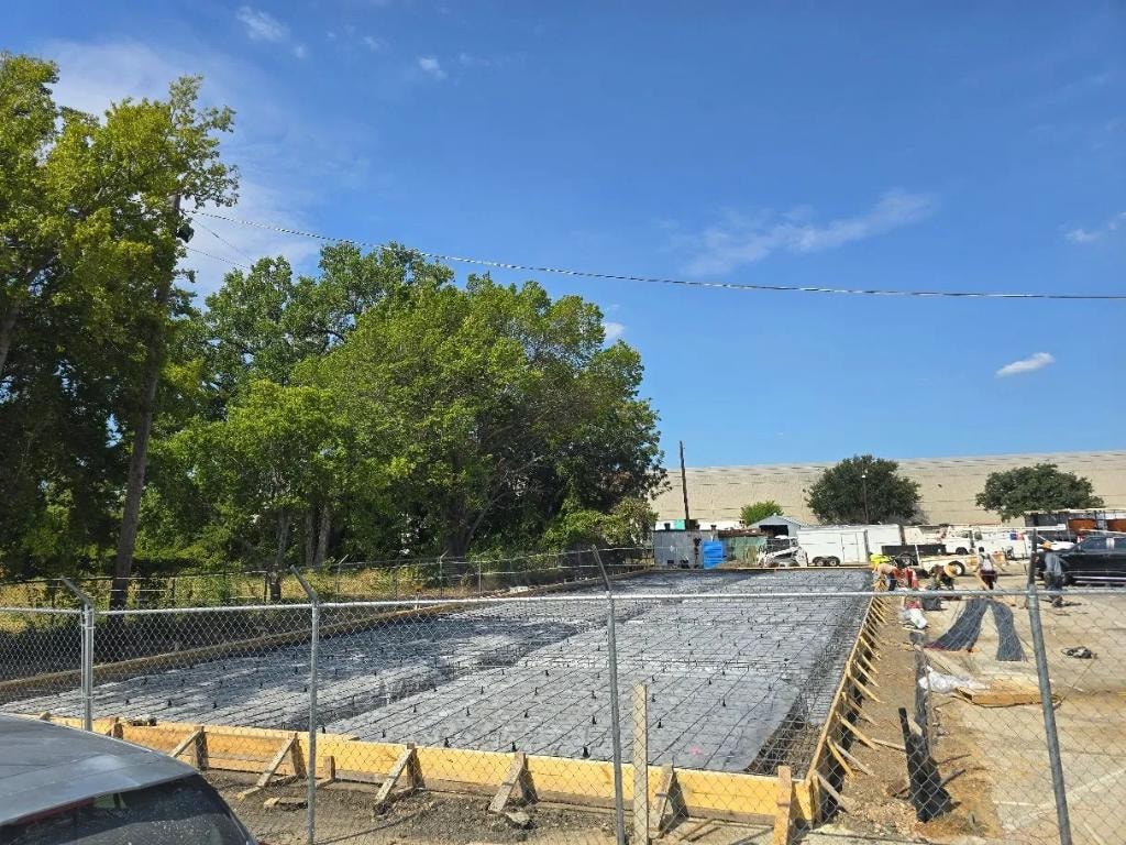 Large concrete slab project at fenced commercial site