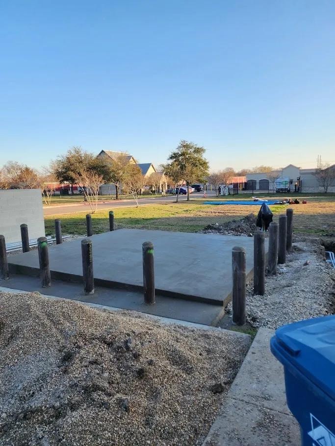 Residential concrete pad with bollards