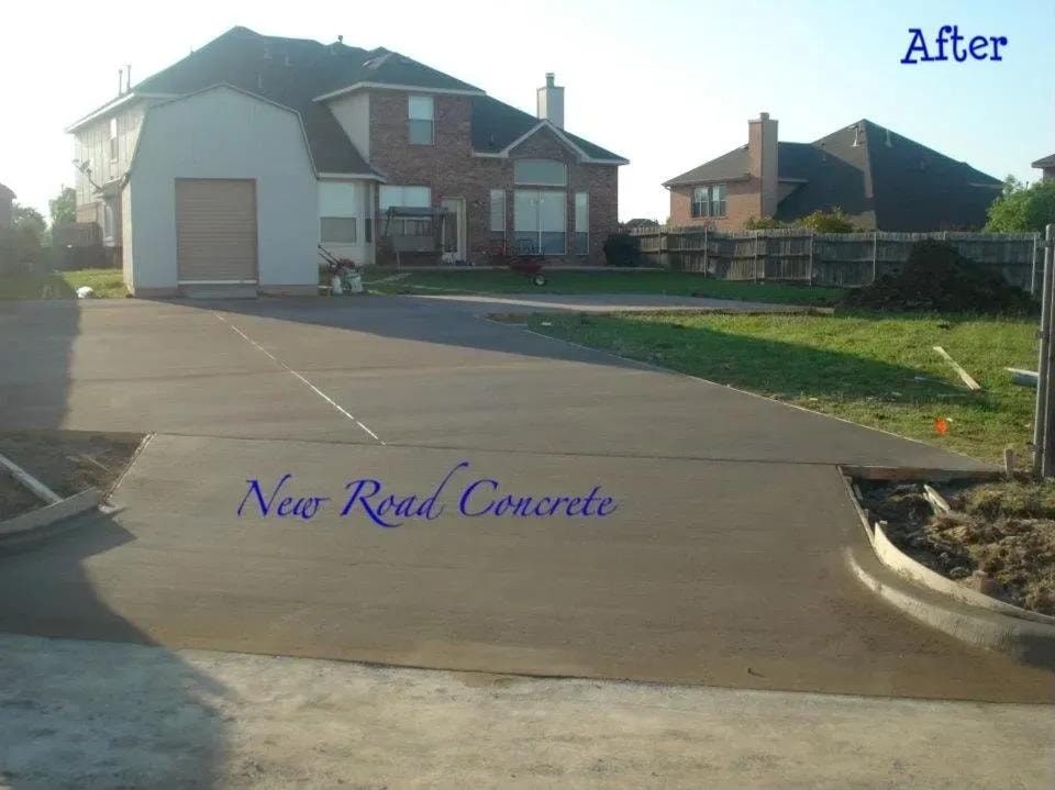 After: large finished concrete driveway at suburban home
