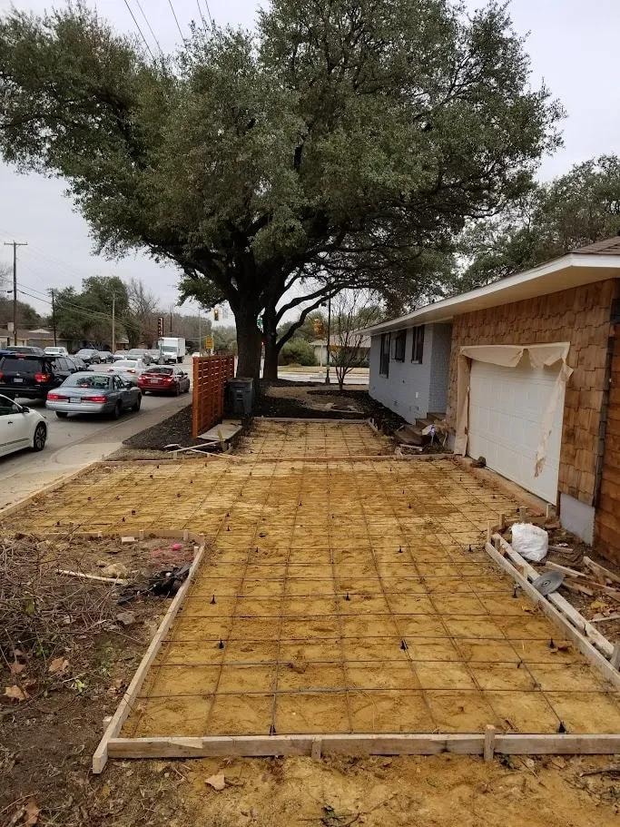 Before: rebar grid and formwork for driveway at cedar siding home
