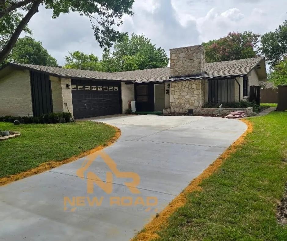 Curved concrete driveway at stone and brick home in DFW