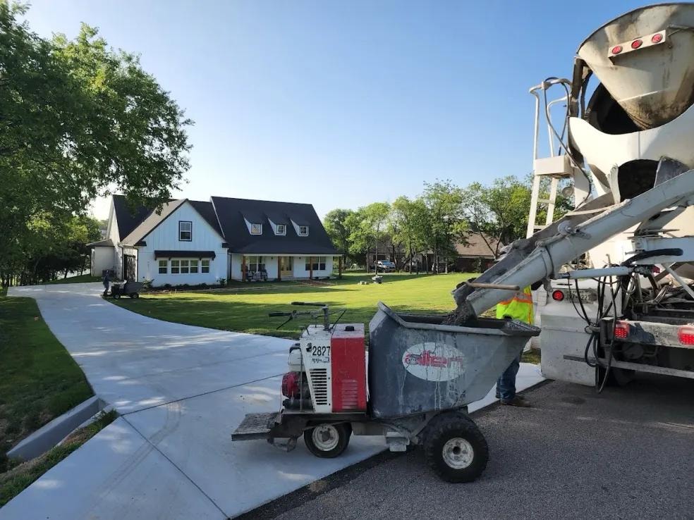 Cement truck pouring concrete driveway at farmhouse